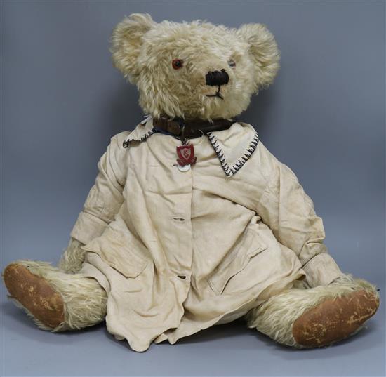 A Farnell teddy bear, Fraser, c.1928, with pale blond curly mohair, deep amber and black glass eyes, clipped snout,